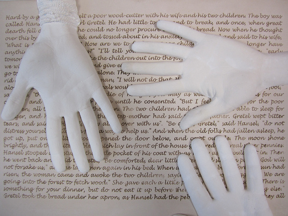 hand casts and text are juxtaposed
