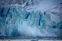 Calving glacier. Birth of an iceberg