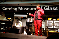 Shaw demonstrating glass blowing on the Corning mobile hot shop