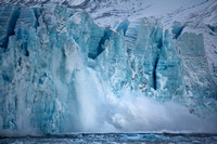Calving glacier. Birth of an iceberg