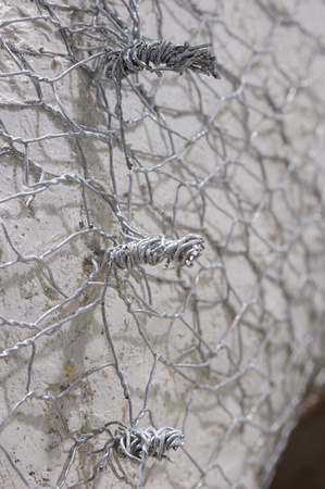 Chicken wire is twisted to make it tight round the mould