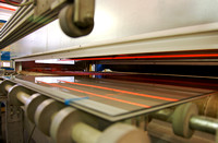 Glass passing through heaters to melt inter layer