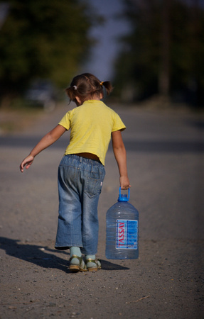 Girl carrying water to her home